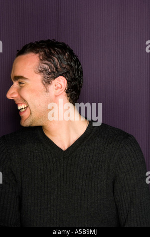Young man posing and laughing in photo booth. Stock Photo