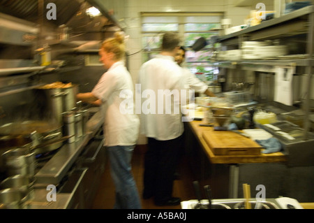 Team of restaurant kitchen staff busy at work. Stock Photo