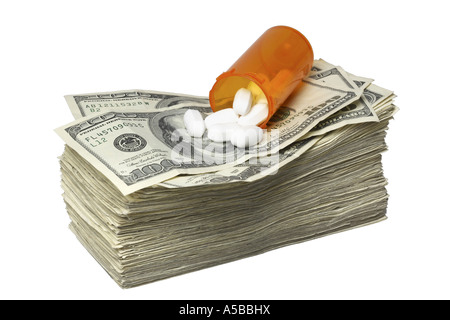 Pill Bottle on Stack of Money cut out on white background Stock Photo