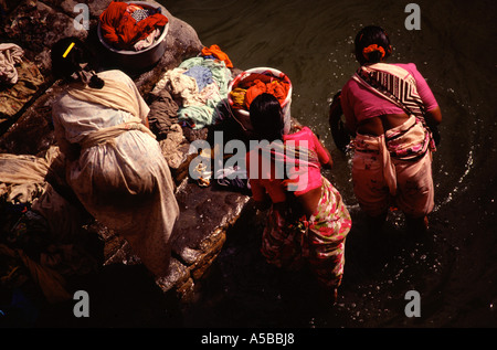 Women wash laundry at the shore of Agastya (Tirtha) lake in Badami located in the Bagalkot district of Karnataka, India Stock Photo