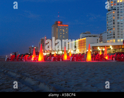 Restaurant lanterns lit up at night at Frishman beach at the Mediterranean seashore of Tel Aviv in Israel Stock Photo