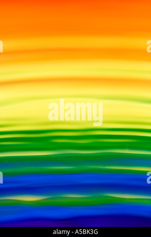 Rainbow water reflections abstract background. Water on a plate mirror with reflected colour Stock Photo