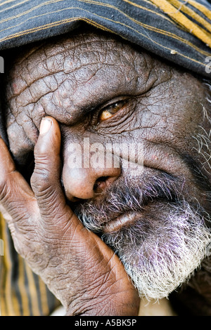 Old Indian man with his head in his hands. Andhra Pradesh, India Stock Photo