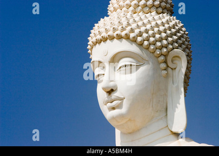 White Buddha statue against blue sky in South India Stock Photo