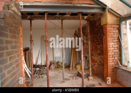 ACROW PROPS SUPPORTING AN RSJ WHILE CONCRETE PADSTONES SET TO ALLOW THE ENLARGEMENT OF A WALL OPENING Stock Photo