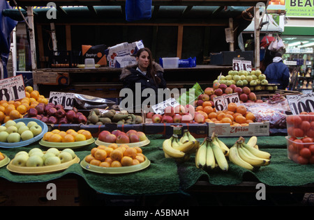 Vendor at fruit stall on street, Brixton market, London, England, UK Stock Photo