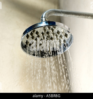 Water jet from wide shower head conservation shortages and rationing, political global issue Stock Photo
