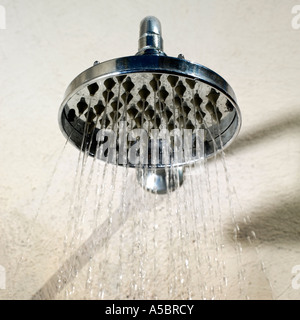 Water jet from wide shower head conservation shortages and rationing, political global issue Stock Photo