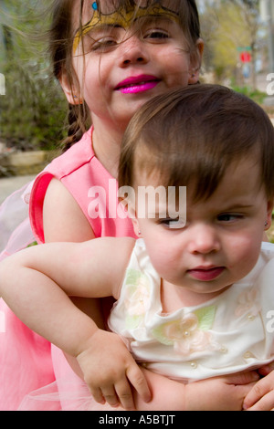 Sisters in their Easter dresses age one and three. St Paul Minnesota USA Stock Photo