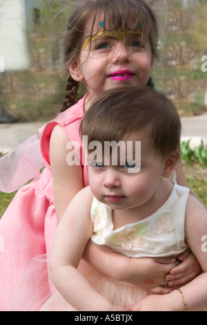 Sisters in their Easter dresses age one and three. St Paul Minnesota USA Stock Photo