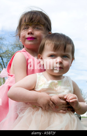 Sisters in their Easter dresses age one and three. St Paul Minnesota USA Stock Photo