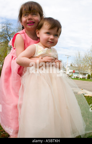 Sisters in their Easter dresses age one and three. St Paul Minnesota USA Stock Photo
