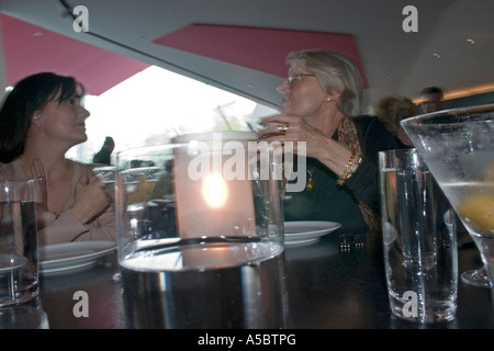 Women MR enjoying a good conversation over cocktails age 39 and 68. Wolfgang Puck 20.21 Restaurant Minneapolis Minnesota USA Stock Photo