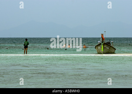 Visitors snorkel off the low tide sand bar between Ko Tup and Ko Kai islands near Krabi Thailand Stock Photo