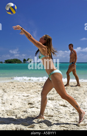 Young woman in green bikini serving playing beach volleyball Chaweng Beach Ko Samui island Thailand Stock Photo