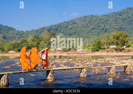 Monks crossing a river near Vang Vieng, Laos