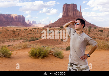 A young man standing in Monument Valley, Arizona Stock Photo