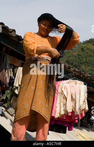 Akha Chinese Minority Woman Combing Long Black Hair Yaoqu, Xishuangbanna, Southern Yunnan, China Stock Photo