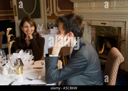 Couple chatting and waiting for their food in a restaurant Stock Photo