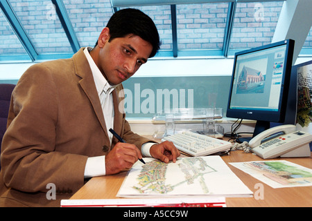 London-based architect Amit working on plans Stock Photo