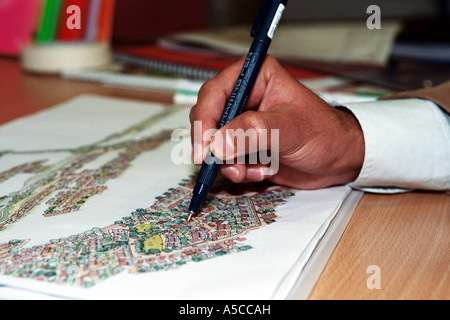 London-based architect Syed Shar working on plans Stock Photo