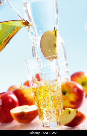Pouring apple juice into glass Stock Photo