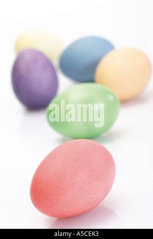 Festive Easter background. Multicoloured Easter eggs on a blue table ...