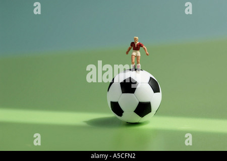 Toy figurine on football Stock Photo