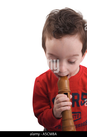 Little boy playing the flute Stock Photo