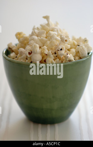 Freshly popped popcorn in green pottery bowl Stock Photo