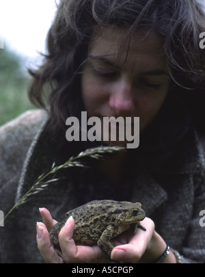 Girl with common toad Stock Photo