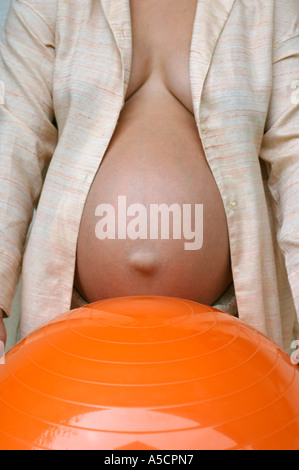 belly of a pregnant woman and rubber ball Stock Photo