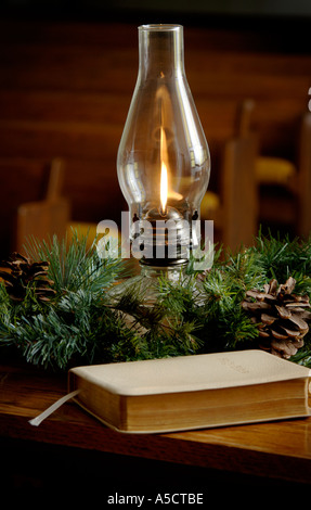 Oil lamp and Bible in church setting Stock Photo