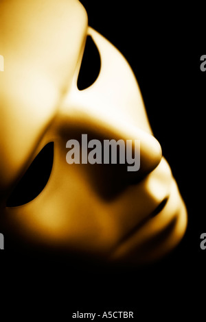 Costume mask photographed in moody lighting sepia toned Stock Photo