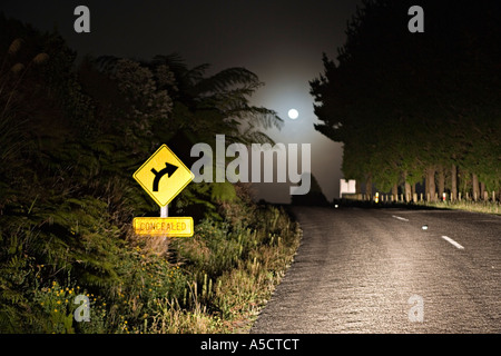 Moonset over road at night Stock Photo