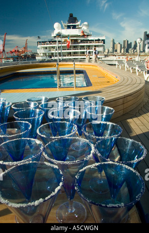 Holland America ms Veendam and Celebrity Cruise Lines Summit cruise ships in the port of Seattle with drinks in foreground Stock Photo