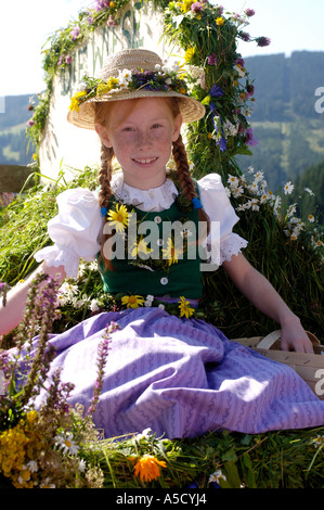 Austria, Salzburg land, Girl in traditional costume sitting in wagon Stock Photo