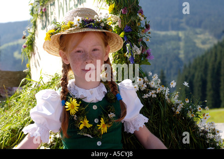 Austria, Salzburg land, Girl in traditional costume sitting in wagon Stock Photo