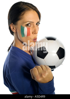Woman with Italian flag painted on her face with football punching air Stock Photo
