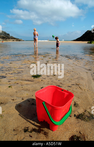 Red beach bucket on a sandy beach in Belle Ile en Mer Stock Photo