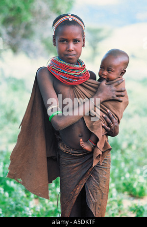 Rendille young woman carrying her baby sister Northern Kenya East Africa Stock Photo