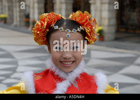 Young girl in traditional clothing smiles during Chinese New Year celebrations in Macao China Stock Photo