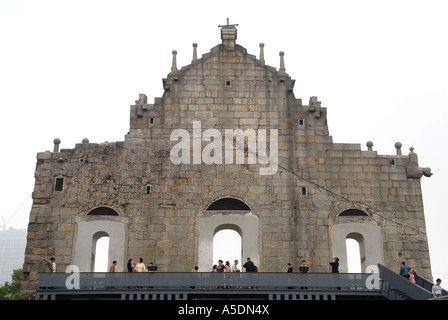 Tourists walking along the rear facade of the 17th-century Portuguese church of St Paul's in Santo António, Macau, China Stock Photo