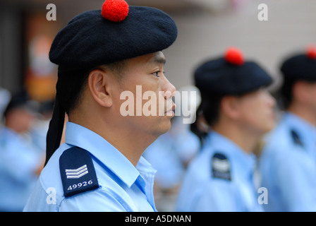 Chinese policeman wearing the traditional Scottish Balmoral hat taking part in the Hong Kong Chinese New Year Parade in China Stock Photo