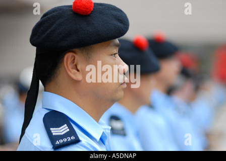 Policemen wearing the traditional Scottish Balmoral hat taking part in the Hong Kong Chinese New Year Parade in China Stock Photo