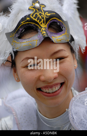 Young Chinese girl in festive outfit happy and smiling during Chinese Lunar New Year celebrations in Kowloon, Hong Kong, China Stock Photo