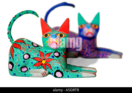Mexican wooden cat figurines shown as a cut-out Stock Photo