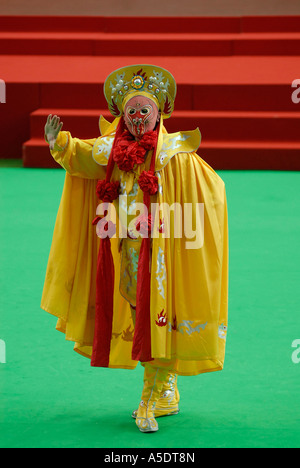 A performer wearing  vividly colored mask and costume performing Bian Lian 'Face-Changing' ancient dramatic art that is part of Sichuan opera in China Stock Photo