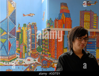 A Chinese youngster stands in front of illustrated mural, Hong Kong China Stock Photo