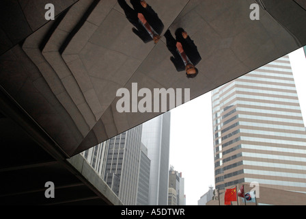 Pedestrian reflected in a passage ceiling Hong Kong island China Stock Photo